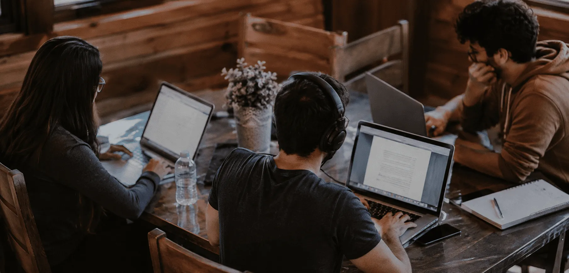 Solo content writer working at a moody home desk setup with a microphone